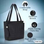 Black women’s tote handbag with comfortable shoulder straps and decorative brooch