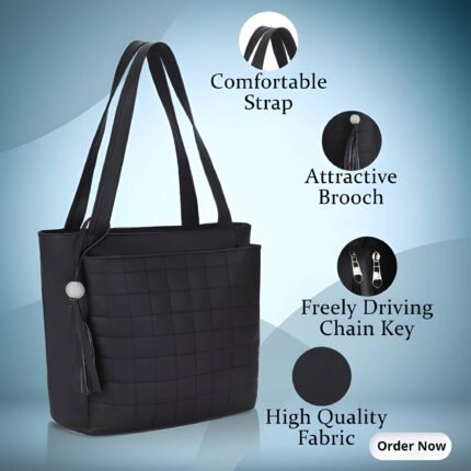 Black women’s tote handbag with comfortable shoulder straps and decorative brooch