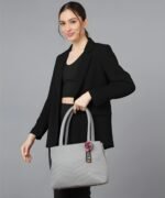Women’s light grey tote handbag with wave pattern, adjustable shoulder strap and pom-pom charm