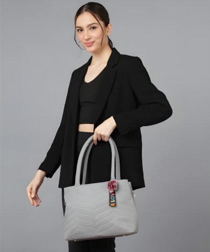 Women’s light grey tote handbag with wave pattern, shoulder strap and pom-pom charm