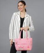 Women’s pink tote handbag with floral embroidery and multiple zipper pockets