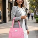 Women’s pink tote handbag with quilted front pocket and zipper