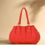 Women’s red tote handbag with spacious interior and zipper closure