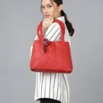 Woman carrying red honeycomb pattern tote handbag with shoulder strap