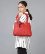 Woman carrying red honeycomb pattern tote handbag with shoulder strap